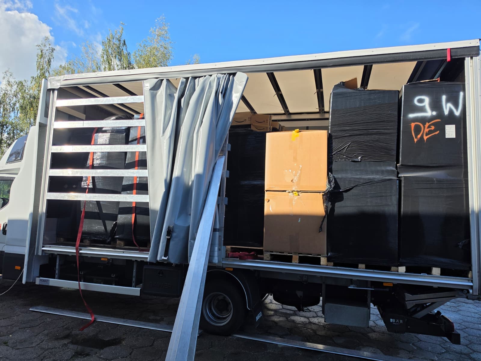 Pallets of unclaimed parcels and Amazon boxes loaded onto a vehicle as part of a 12-pallet order for a customer in Germany