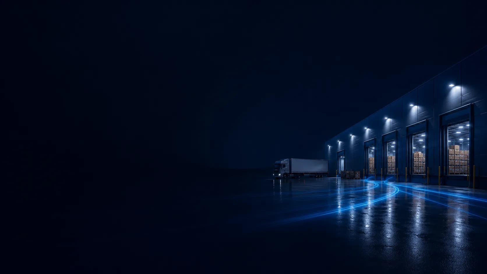 Magazyn logistyczny nocą - rampy załadunkowe i ciężarówka przed halą